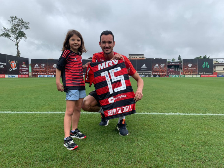 A filha de Gustavo De Conti, Bruna, com o capitão Réver (Gilvan de Souza/ Flamengo) A filha de Gustavo De Conti, Bruna, com o capitão Réver (Gilvan de Souza/ Flamengo)